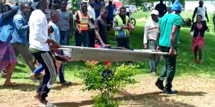 SENSITIVE MATERIAL. THIS IMAGE MAY OFFEND OR DISTURB Body of a victim is carried following a shooting at a Kumba school, Cameroon