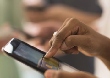 Close up of woman using cell phone touch screen
