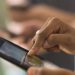 Close up of woman using cell phone touch screen