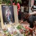 Mourners place a candles and flowers in the courtyard of Radio Amplitude FM, during a tribute ceremony for journalist Martinez Zogo, in the Elig Essono district of Yaounde on January 23, 2023. - A popular Cameroon radio journalist who had been missing following what a media rights group called an abduction has been found dead, his employer and police said on January 22, 2023.
Martinez Zogo was managing director of Yaounde-based private radio station Amplitude FM and the star host of a popular daily programme, Embouteillage (Gridlock).
On the air, the 51-year-old regularly tackled cases of corruption, not hesitating to question important personalities by name. (Photo by Daniel Beloumou Olomo / AFP)