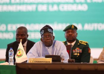 Chairperson of Economic Community of West African States (ECOWAS) and President of Nigeria, Bola Ahmed Tinubu, reacts while addressing the ECOWAS head of states and government in Abuja on July 30, 2023. West African leaders were to meet on Sunday for a crisis summit on the coup in Niger, where protesters tried to storm the French embassy after the junta warned of an "imminent military intervention". In the third coup to fell a leader in Africa's restive Sahel region in as many years, Niger's elected president, Mohamed Bazoum, has been held by the military since Wednesday. (Photo by Kola SULAIMON / AFP)