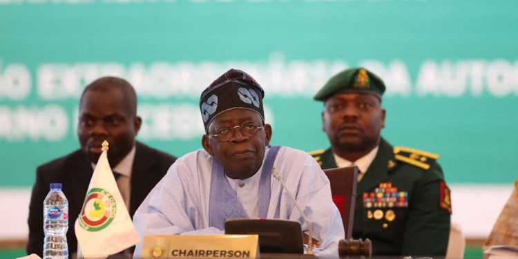 Chairperson of Economic Community of West African States (ECOWAS) and President of Nigeria, Bola Ahmed Tinubu, reacts while addressing the ECOWAS head of states and government in Abuja on July 30, 2023. West African leaders were to meet on Sunday for a crisis summit on the coup in Niger, where protesters tried to storm the French embassy after the junta warned of an "imminent military intervention". In the third coup to fell a leader in Africa's restive Sahel region in as many years, Niger's elected president, Mohamed Bazoum, has been held by the military since Wednesday. (Photo by Kola SULAIMON / AFP)