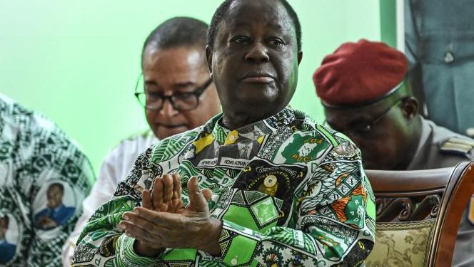 (FILES) Former Ivorian president and president of the Democratic Party of Cote d'Ivoire (PDCI) Henri Konan Bedie (c) applauds during the 7th session of the extraordinary congress of the PDCI-RDA at the party's headquarter in Abidjan on March 30, 2023. Former Ivory Coast president Henri Konan Bedie dies aged 89 announced the party in a statement on August 1, 2023.
 (Photo by Sia KAMBOU / AFP)
