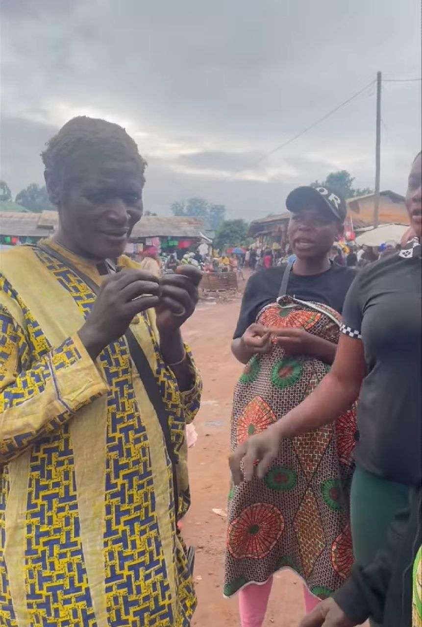 A dirty-looking mentally ill woman stands along the streets with two women