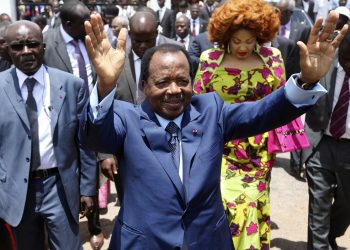 FILE - In this Sunday Oct 9, 2011 file photo, Cameroon President Paul Biya waves after casting his vote during the presidential elections in Yaounde, Cameroon. A bloody conflict between Cameroon's government and Anglophone separatists over language is now threatening next month's presidential election. The 85-year-old President Paul Biya, one of Africa's longest-serving leaders, vows to hold the largely Francophone country together even as thousands flee violence in English-speaking regions. (AP Photo/Sunday Alamba, File)