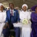 A man with his wife and two of his brides sits inside a marquee ahead of the mass Easter weddings for 3,000 people, some polygamous, at the International Pentecost Holiness Church in Heidelberg, east of Johannesburg, South Africa, Sunday, April 20, 2025. (AP Photo/Themba Hadebe)