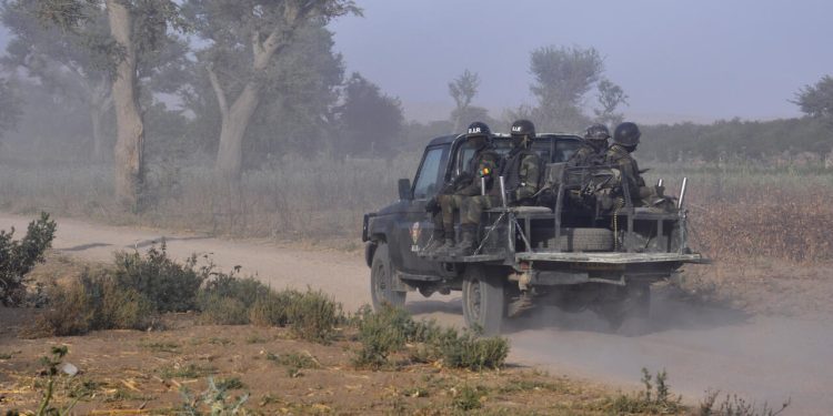 Members of the Cameroonian Rapid Intervention Force patrol on the outskirt of Mosogo in the far north region of the country where Boko Haram jihadist have been active since 2013, on March 21, 2019. (Photo by Reinnier KAZE / AFP)