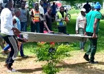 SENSITIVE MATERIAL. THIS IMAGE MAY OFFEND OR DISTURB Body of a victim is carried following a shooting at a Kumba school, Cameroon