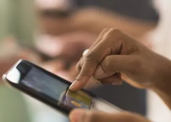 Close up of woman using cell phone touch screen