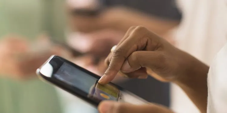 Close up of woman using cell phone touch screen