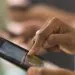 Close up of woman using cell phone touch screen