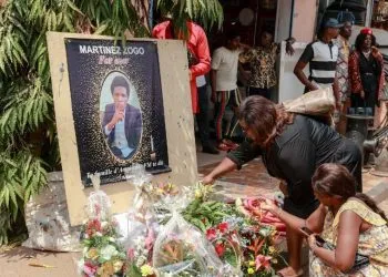 Mourners place a candles and flowers in the courtyard of Radio Amplitude FM, during a tribute ceremony for journalist Martinez Zogo, in the Elig Essono district of Yaounde on January 23, 2023. - A popular Cameroon radio journalist who had been missing following what a media rights group called an abduction has been found dead, his employer and police said on January 22, 2023.
Martinez Zogo was managing director of Yaounde-based private radio station Amplitude FM and the star host of a popular daily programme, Embouteillage (Gridlock).
On the air, the 51-year-old regularly tackled cases of corruption, not hesitating to question important personalities by name. (Photo by Daniel Beloumou Olomo / AFP)