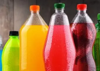 Plastic bottles of assorted carbonated soft drinks in variety of colors