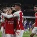 Arsenal's Belgian midfielder #19 Leandro Trossard (C) celebrates with teammates after scoring his team third goal during the English Premier League football match between Arsenal and Liverpool at the Emirates Stadium in London on February 4, 2024. (Photo by Ian Kington / IKIMAGES / AFP)