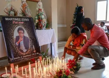 Mourners place candles in a room of Radio Amplitude FM where a portrait of journalist Martinez Zogo has been placed to pay tribute to him, in the Elig Essono district in Yaounde on January 23, 2023. A popular Cameroon radio journalist who had been missing following what a media rights group called an abduction has been found dead, his employer and police said on January 22, 2023.
Martinez Zogo was managing director of Yaounde-based private radio station Amplitude FM and the star host of a popular daily programme, Embouteillage (Gridlock).
On the air, the 51-year-old regularly tackled cases of corruption, not hesitating to question important personalities by name. (Photo by Daniel Beloumou Olomo / AFP)