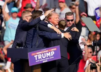 Republican presidential candidate former President Donald Trump is helped off the stage at a campaign event in Butler, Pa., Saturday, July 13, 2024. (AP Photo/Gene J. Puskar)
