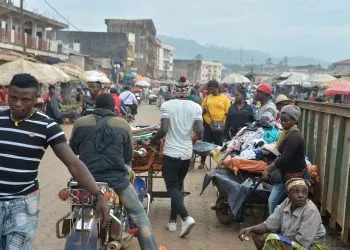 People walk at the food market in Bamenda on November 15, 2017, after a homemade bomb exploded overnight on November 12. Authorities in Cameroon have imposed a night-time curfew on November 8, 2017 and ordered the closure of shops and public places in the main city in a region rocked by unrest among the country's anglophone minority. Four makeshift bombs exploded overnight on November 12, a week after four soldiers were killed in the two administrative areas where most of Cameroon's anglophone minority live. Their deaths have been blamed by the authorities on 