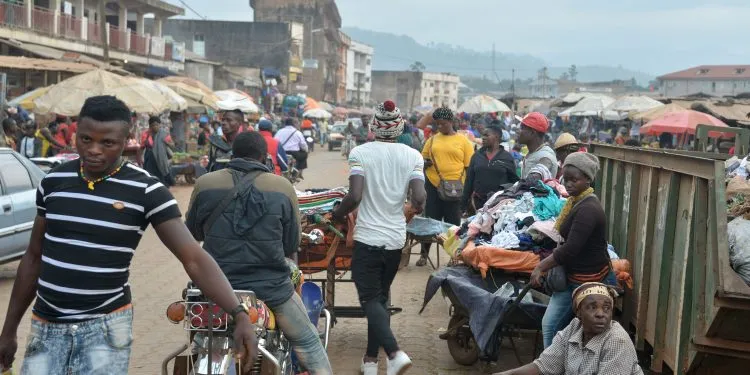 People walk at the food market in Bamenda on November 15, 2017, after a homemade bomb exploded overnight on November 12. Authorities in Cameroon have imposed a night-time curfew on November 8, 2017 and ordered the closure of shops and public places in the main city in a region rocked by unrest among the country's anglophone minority. Four makeshift bombs exploded overnight on November 12, a week after four soldiers were killed in the two administrative areas where most of Cameroon's anglophone minority live. Their deaths have been blamed by the authorities on 