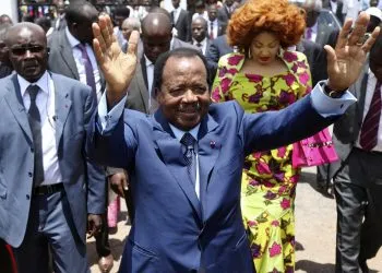 FILE - In this Sunday Oct 9, 2011 file photo, Cameroon President Paul Biya waves after casting his vote during the presidential elections in Yaounde, Cameroon. A bloody conflict between Cameroon's government and Anglophone separatists over language is now threatening next month's presidential election. The 85-year-old President Paul Biya, one of Africa's longest-serving leaders, vows to hold the largely Francophone country together even as thousands flee violence in English-speaking regions. (AP Photo/Sunday Alamba, File)