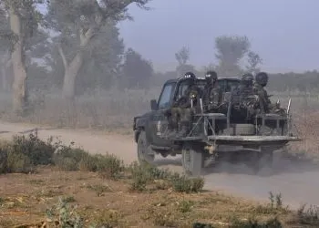 Members of the Cameroonian Rapid Intervention Force patrol on the outskirt of Mosogo in the far north region of the country where Boko Haram jihadist have been active since 2013, on March 21, 2019. (Photo by Reinnier KAZE / AFP)